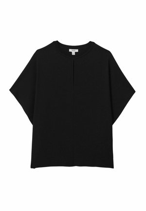 Black oversized t-shirt made of soft fabric. Features a round neckline, short sleeves, and a central seam detail for added texture.
