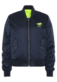 Navy blue bomber jacket made of smooth fabric, featuring a bright green lining, front zip closure, and ribbed cuffs with side pockets.