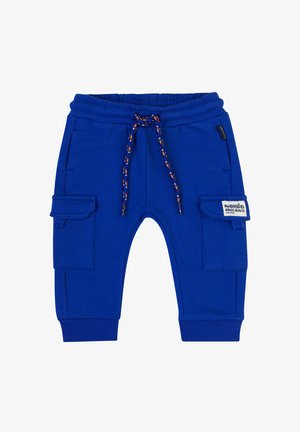 Niebieskie dresy z elastycznym paskiem na sznurek, ściągaczami na mankietach i dwiema bocznymi kieszeniami cargo. Zawierają naszywkę na prawej kieszeni.