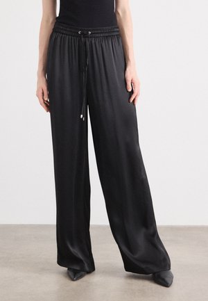 TAVATI - Trousers - black