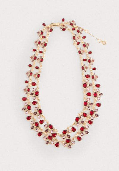 Gold chain necklace with red, pink, and purple teardrop and oval gemstones arranged in floral clusters and drops on a white background.