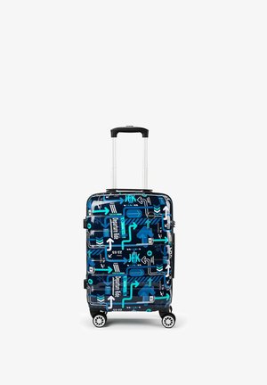 Blue hard-shell suitcase with white, teal, and black travel-themed arrows, JFK text, and airport departure icons, on four spinner wheels with extended handle.