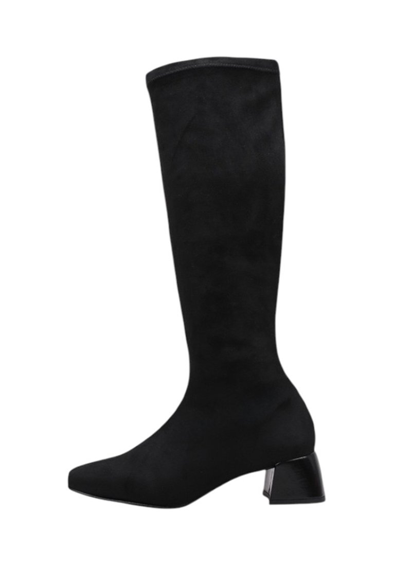 Black knee-high boot made of smooth suede. Features a square toe and a chunky, glossy heel for stability and modern design.