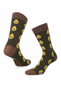 Brązowe skarpetki w zielone wzory awokado. Żebrowane mankiety oraz jednolity brązowy palec i pięta. Wykonane z miękkiego, elastycznego materiału dla komfortu.