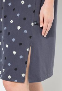 Abito a maniche corte di colore grigio scuro con stampa floreale colorata (bianco, azzurro chiaro, nero) e spacco laterale. Realizzato in Tessuto morbido, design casual.