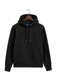 Čierna mikina s kapucňou a šnúrkou, na ktorej je vyvýšené logo GANT a text "American Sportswear". Vyrobená z mäkkej tkaniny s rebrovanými manžetami.