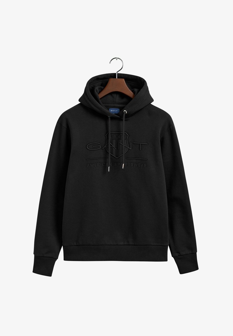 Fekete kapucnis pulóver zsinórral, kiemelkedő GANT logóval és "American Sportswear" felirattal. Puha anyagból készült, bordás mandzsettákkal.