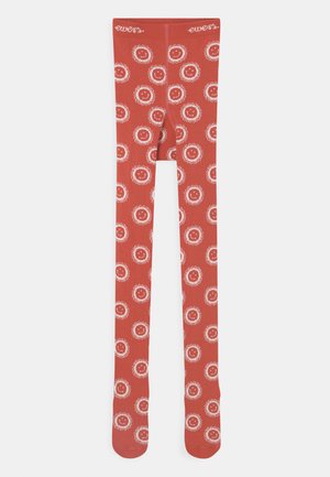 Rote Strumpfhosen mit einem sich wiederholenden Muster aus weißen lächelnden Gesichtern, umgeben von floralen Umrissen. Hergestellt aus einem weichen Stoff mit glatter Textur.