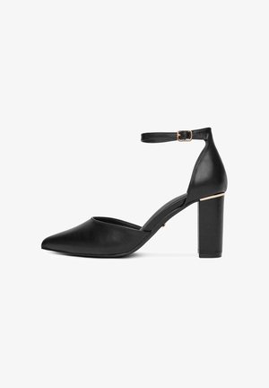 Mustmust nahkainenä kõrge kontsaga king, millel on terav nina, pahkluu rihm ja kuldne aktsent plokkkontsaga. Omab stiliseeritud disaini ja sujuvat tekstuuri.