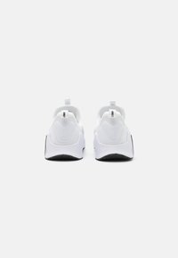 White athletic shoes with a smooth mesh upper, rounded design, and black rubber sole. Features pull tabs on the heel and accent details.