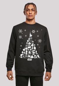 Felpa nera con un design grafico bianco che rappresenta un albero di Natale composto da vari personaggi di "Star Wars", con fiocchi di neve attorno.