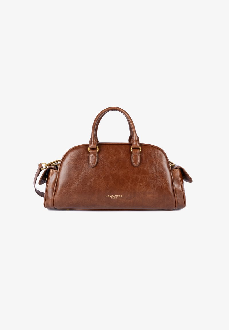 Sac à main en cuir marron avec deux poignées supérieures, accents en métal doré, forme arrondie et logo de la marque sur le devant. Équipé d'une bandoulière amovible.