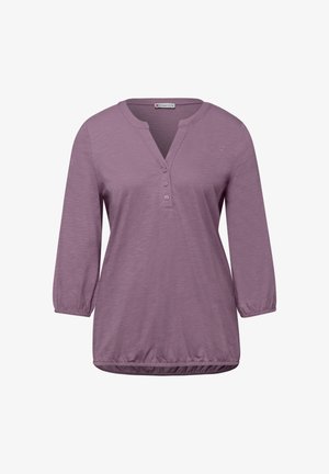 Fliederfarbene Damenbluse mit langen Ärmeln, drei Knöpfen vorne, elastischen Bündchen und gesammeltem Saum.