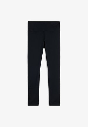 Leggings negros hechos de tela elástica, con una cintura alta y textura suave, con un diseño ajustado hasta los tobillos.