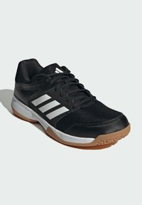 Black athletic shoe featuring mesh and synthetic materials, white stripes, and a gum rubber outsole with a textured pattern.