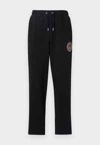Pantalones de chándal negros con cintura elástica y cordón, dos bolsillos laterales y un detalle de logo bordado en el muslo izquierdo. Tejido suave y elástico.