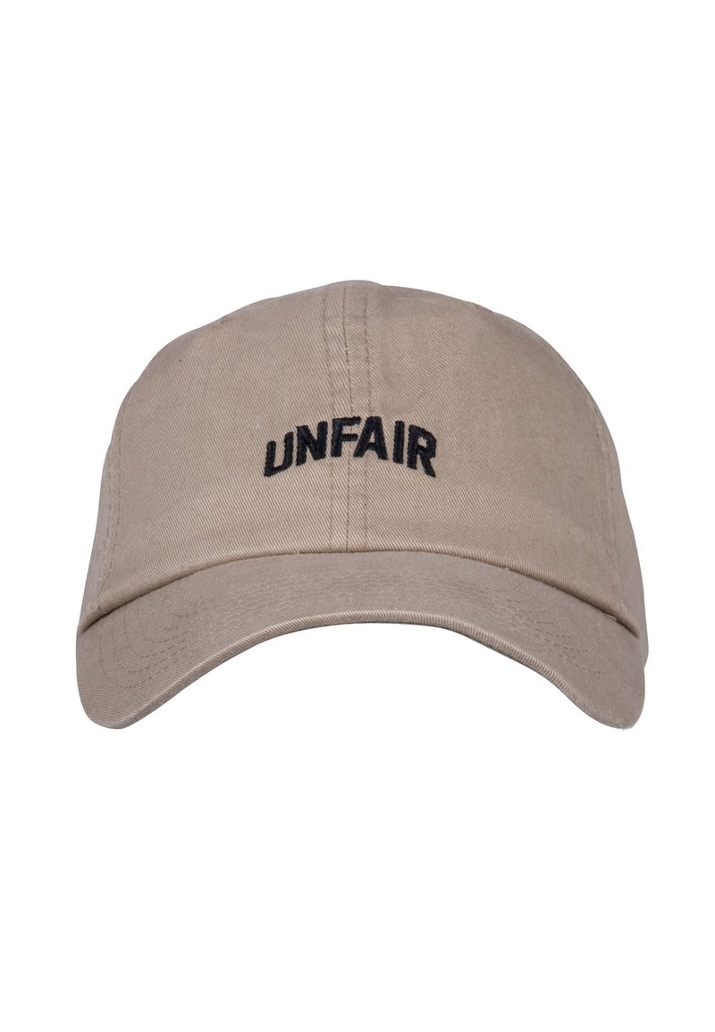 Beige cap with a curved visor, featuring black embroidered text "UNFAIR" on the front. Made of cotton with a smooth texture.
