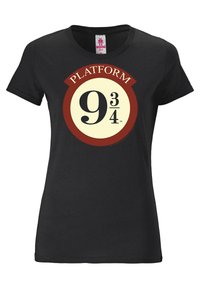 Black cotton t-shirt featuring a circular graphic with "PLATFORM 9¾" in yellow and burgundy, centered on the chest. Short sleeves.