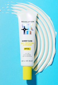 Tube blanche de crème solaire avec un texte holographique, un capuchon jaune, étiqueté "Sunray Glow Protection Quotidienne Crème Solaire SPF 50+," sur un fond bleu.