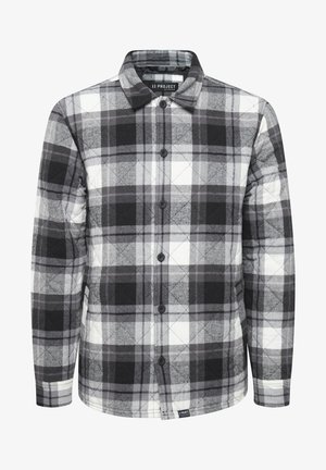 Mustra mustrist ja valge ruuduline särk, millel on nööbitav esiosa, kraega kaelus, sooja tekstuuriga ja pikkade varrukatega, millel on kontrastsete mansettide mustrid.