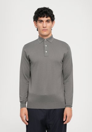 Long-sleeve gray polo shirt with a textured material, buttoned collar, and ribbed hem. Paired with navy pinstriped trousers.