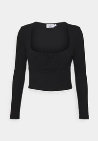 Schwarzes langärmliges Crop-Top mit quadratischem Ausschnitt und gerafftem Vorderteil. Hergestellt aus einem glatten, dehnbaren Stoff. Mit einem Bündchen in der Taille.