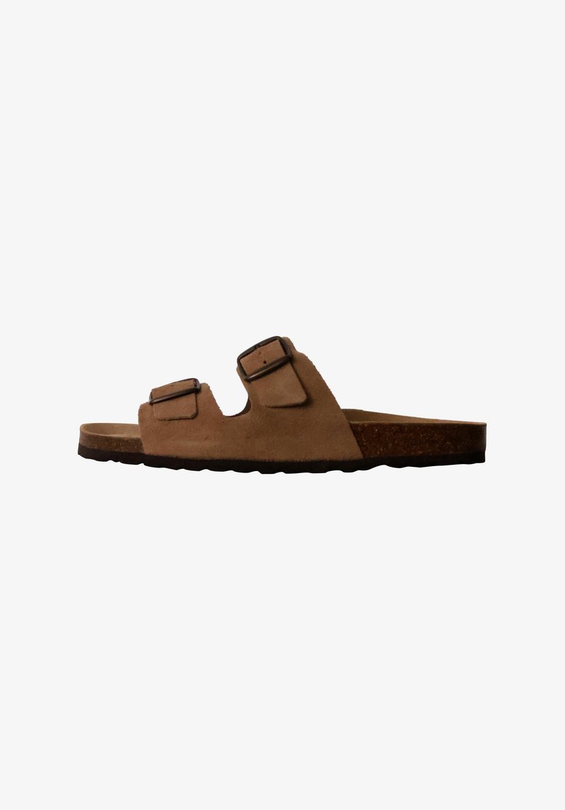 Sandali slip-on in suede marrone con due fibbie regolabili, suola piatta in sughero, suola in gomma testurizzata e design open-toe.