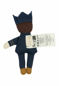 Soft fabric doll in navy uniform, brown face, with a crown-shaped hat. Features cream arms and brown shoes. Includes care label attached.