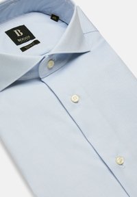Chemise bleu clair en tissu lisse, dotée d'un col standard, d'une patte de boutonnage avec des boutons blancs et d'un motif de texture subtil.