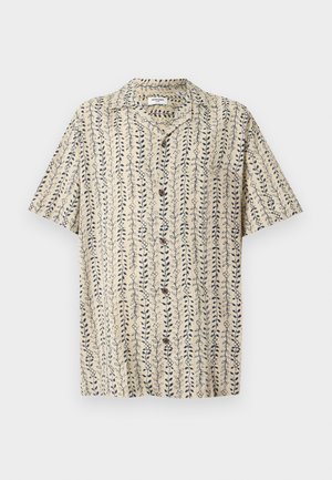 Chemise beige à manches courtes avec boutons, motif vertical bleu de feuilles et de vignes, col pointu.