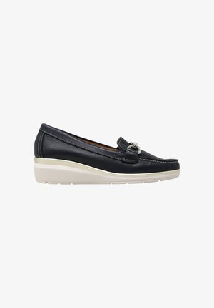 Mocassino slip-on in pelle nera con suola platform bianca e dettaglio fibbia argento sulla parte superiore, visto di lato su sfondo bianco.