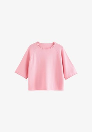 Roze top met korte mouwen gemaakt van zachte stof. Heeft een ronde halslijn en raglanmouwen. Eenvoudig, losmodel ontwerp zonder extra patronen.