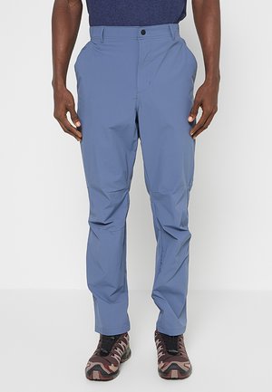 Lekkie niebieskie spodnie trekkingowe o gładkiej fakturze, z zapięciem na zamek błyskawiczny i guzik z przodu oraz dwiema bocznymi kieszeniami.