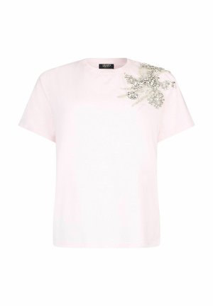T-shirt en coton rose à manches courtes, avec un motif floral orné de perles argentées et de strass sur l'épaule gauche.
