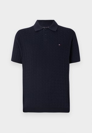 Navy short-sleeve polo shirt made of textured knit fabric, featuring a classic collar and a small logo accent on the chest.