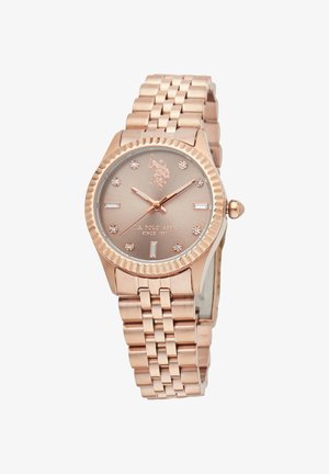 Montre en or rose avec un boîtier rond texturé, un cadran lisse avec des accents en diamant, et un bracelet à maillons.