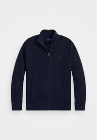 Tummansininen täysimittainen vetoketjullinen neulecardigan, jossa on korkea kaulus, kaksi etutaskua ja pieni brodeerattu logo rinnassa.