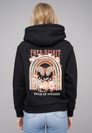 Black hoodie with a large colorful graphic on the back, featuring a butterfly, flowers, and text "FREE SPIRIT" and "DREAM ON DREAMER."