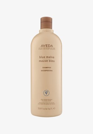 Aveda Blue Malva Shampoo in een beige plastic fles, ronde vorm, met een bruine flip-top deksel en minimalistische label op de voorkant.