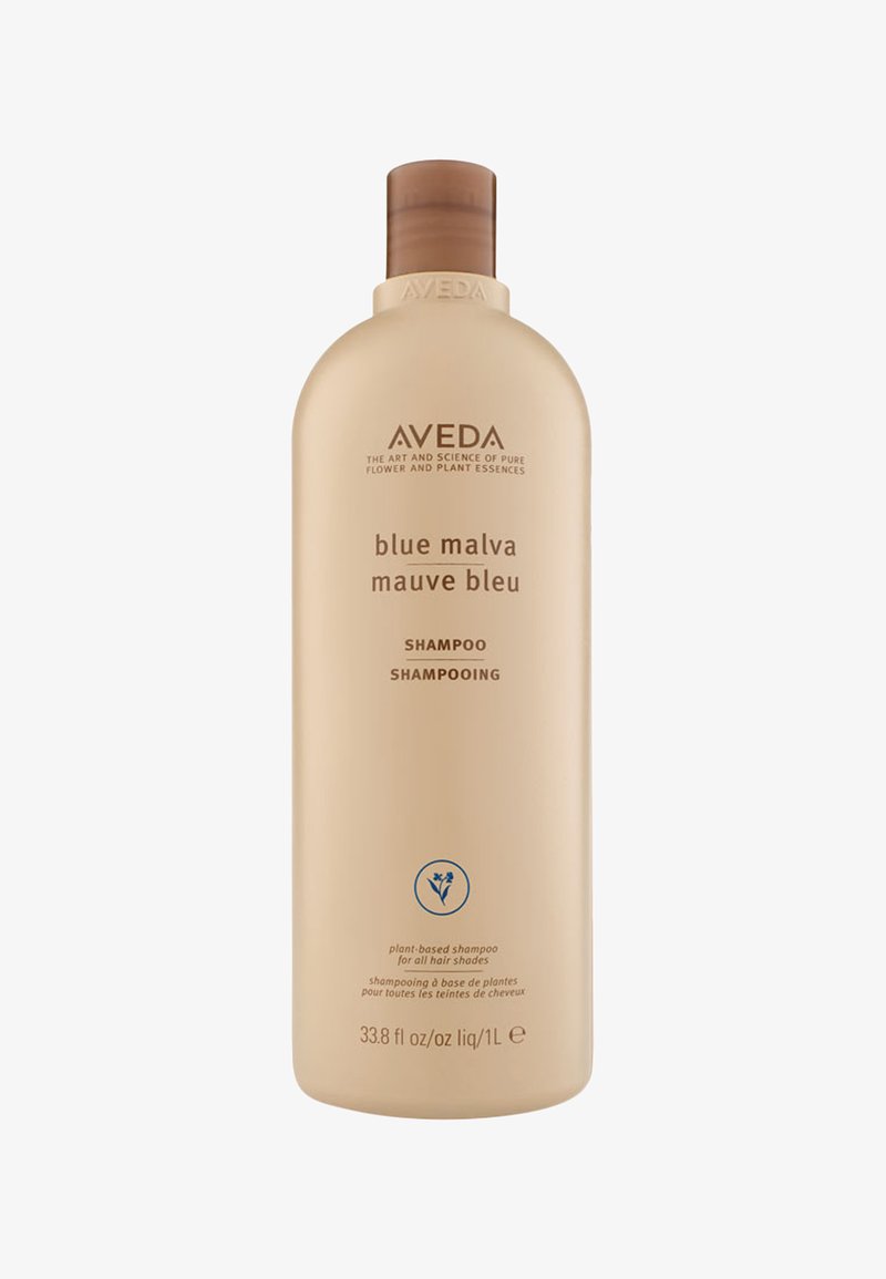 Aveda Blue Malva Shampoo dalam botol plastik beige, berbentuk bulat, dengan penutup flip-top coklat dan label minimalis di bagian depan.