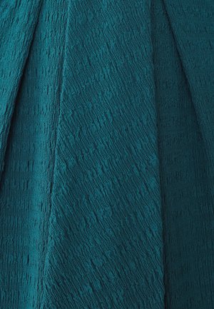 Rohu tekstuuriga teal värvi kangas lainelise, lokkis pinnaga, millel on erinevad kihid ja sügavus, sobib rõivaste või sisekujunduse rakenduseks.