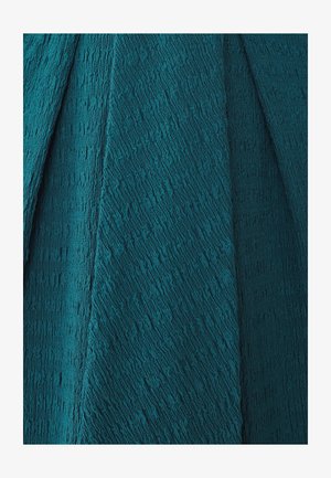 Rohu tekstuuriga teal värvi kangas lainelise, lokkis pinnaga, millel on erinevad kihid ja sügavus, sobib rõivaste või sisekujunduse rakenduseks.