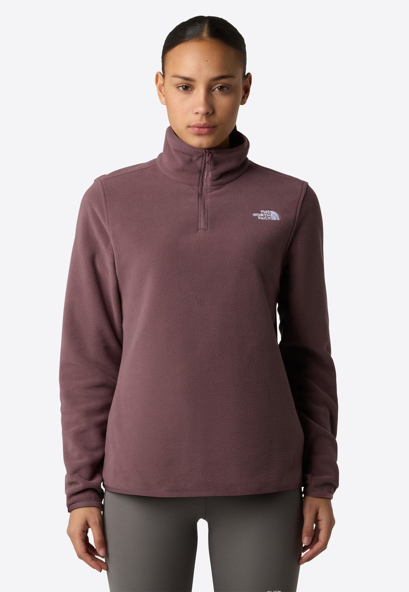 Fleece pullover in mauve, met een kraag met halve rits, lange mouwen en een logo-accent op de borst. Soepele textuur, ontspannen pasvorm.