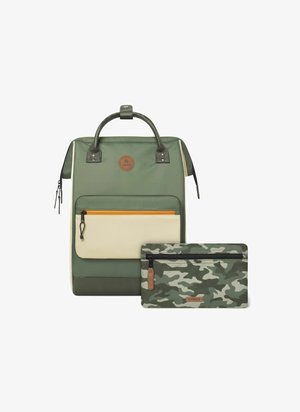 Green nylon backpack with tan accents, a front zip pocket with orange zipper, and a matching camo zip pouch. Rounded handle at the top.