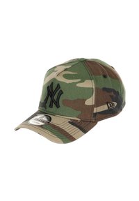 Camouflage-patterned cap in green and brown, featuring a black embroidered 'NY' logo, curved brim, and a tag on the underside.