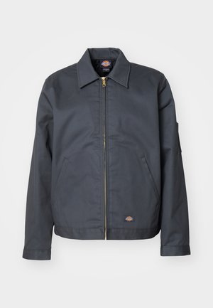 Dark gray jacket made of sturdy fabric. Features a collar, front zip, side pockets, and a small logo on the lower front. Smooth texture.