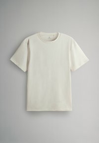 Hellbeige Baumwoll-T-Shirt mit Rundhalsausschnitt und kurzen Ärmeln. Verfügt über eine glatte Textur und ein minimalistisches Design. Keine sichtbaren Muster oder Grafiken.