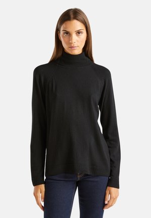 Pull à col roulé noir en tissu tricoté doux, doté de longues manches et d'une coupe décontractée, avec des accents côtelés au niveau du col et de l'ourlet.