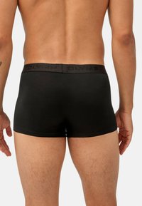 Boxer shorts neri in cotone con una morbida fascia in vita caratterizzata da un logo del brand in rilievo. Texture liscia e design aderente, che offre una copertura completa.