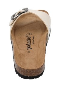 White slide sandal with a cork footbed, featuring a decorative black and silver buckle. Textured sole for grip, size 37 labeled inside.